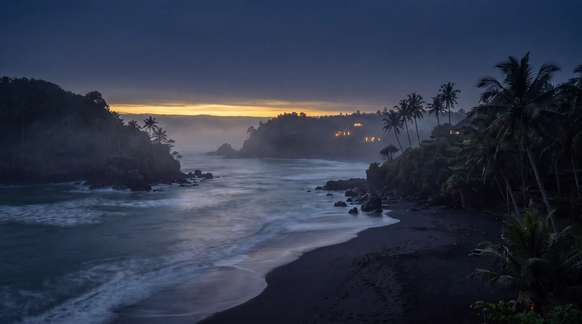 Bali coastline at dusk: navy sky, gold light on the water, palms in silhouette